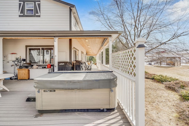 wooden deck with a hot tub