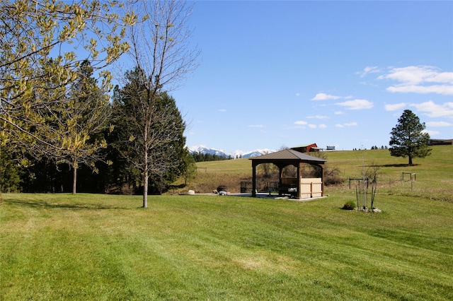 view of yard featuring a gazebo and a rural view