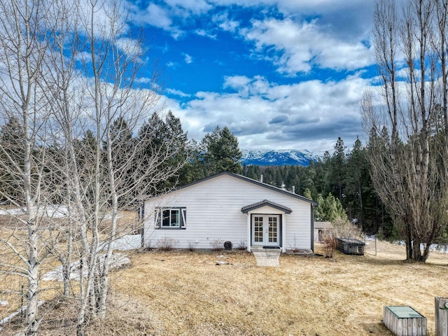 view of side of home featuring french doors and a mountain view
