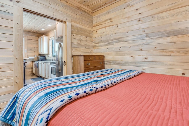 bedroom featuring stainless steel refrigerator with ice dispenser, wood ceiling, and wooden walls