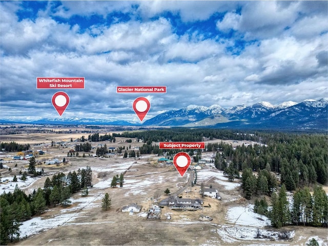 birds eye view of property with a mountain view