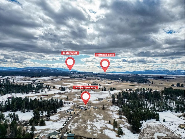 snowy aerial view featuring a mountain view