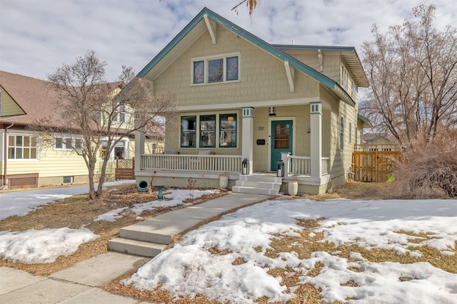 view of front of house featuring a porch and fence