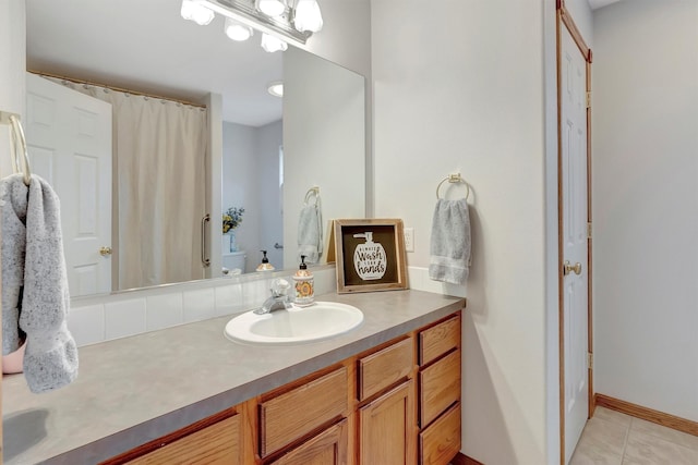 full bathroom with toilet, tile patterned floors, vanity, baseboards, and a shower with curtain