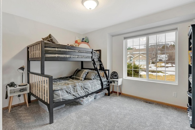 carpeted bedroom featuring visible vents and baseboards