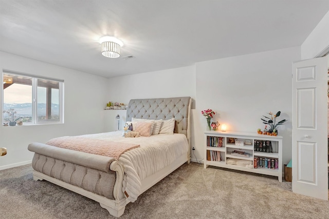 carpeted bedroom featuring visible vents and baseboards