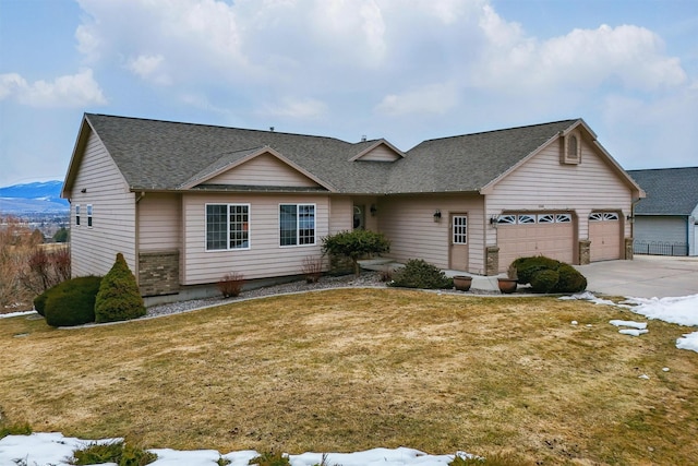 view of front of house featuring driveway, a shingled roof, an attached garage, and a front yard