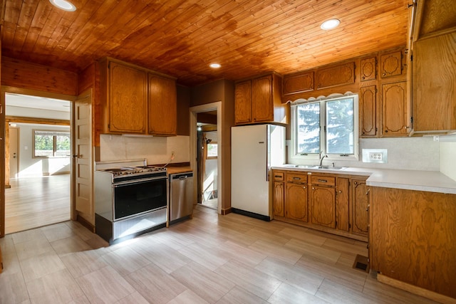13195 US Highway 91 N, Conrad, MT 59425 - kitchen with range, dishwasher, wooden ceiling, brown cabinets, and a sink