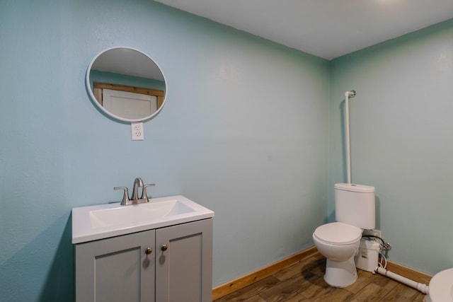 13195 US Highway 91 N, Conrad, MT 59425 - bathroom with toilet, wood finished floors, vanity, and baseboards