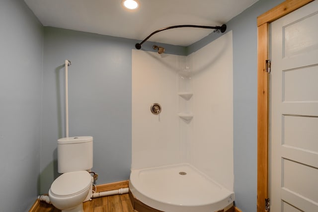13195 US Highway 91 N, Conrad, MT 59425 - bathroom with wood finished floors, a shower, toilet, and baseboards