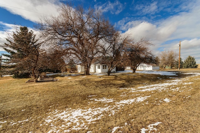 snowy yard with a garage