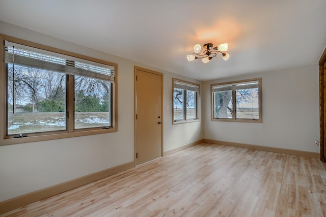 13195 US Highway 91 N, Conrad, MT 59425 - entrance foyer with a chandelier, light wood-style floors, and baseboards