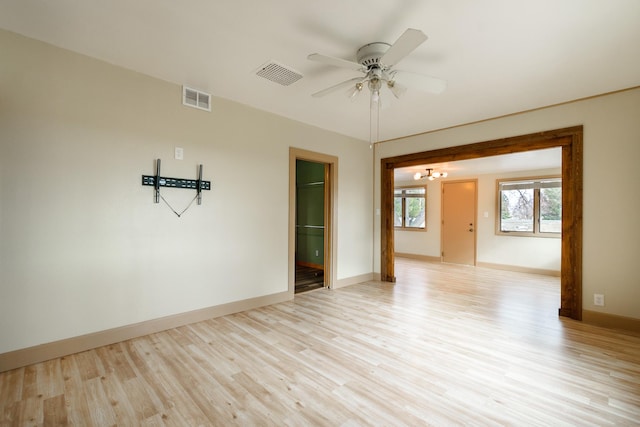13195 US Highway 91 N, Conrad, MT 59425 - unfurnished room featuring light wood-type flooring, ceiling fan, baseboards, and a chandelier