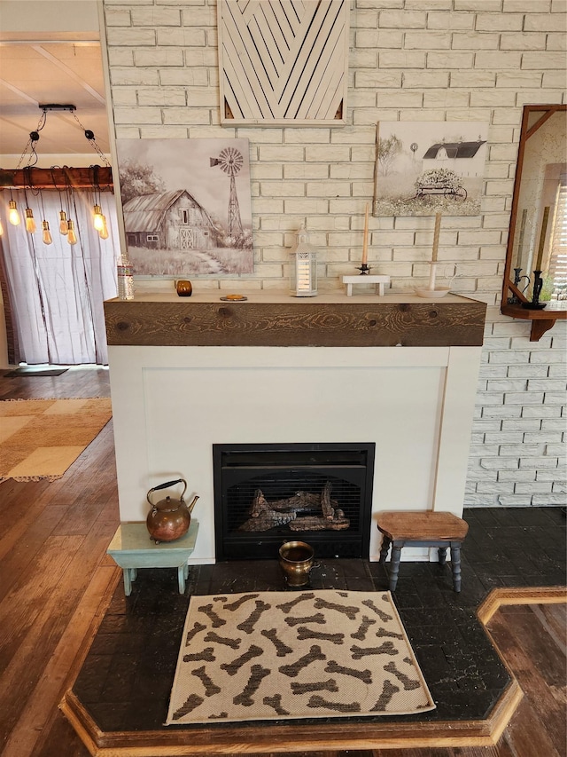 room details with a fireplace with flush hearth and wood finished floors