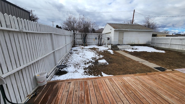 yard layered in snow featuring a fenced backyard and an outdoor structure