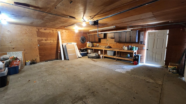 garage with a workshop area and a garage door opener