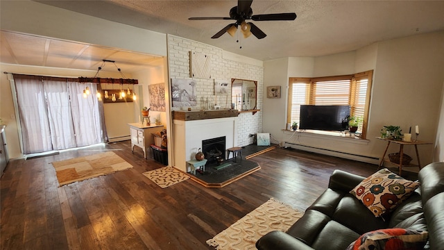 living area featuring a ceiling fan, wood-type flooring, baseboard heating, a textured ceiling, and a baseboard heating unit