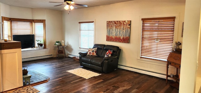 sitting room featuring a baseboard heating unit, ceiling fan, and wood finished floors