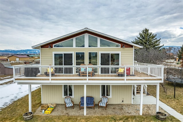 back of house with stairway and a deck