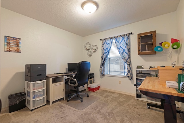 office featuring light carpet, a textured ceiling, and baseboards