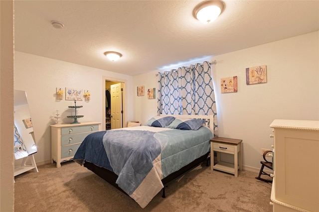 bedroom with light colored carpet and baseboards