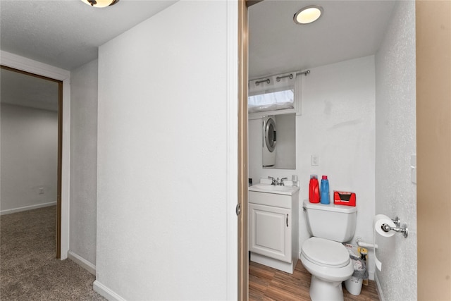 bathroom with vanity, toilet, and baseboards