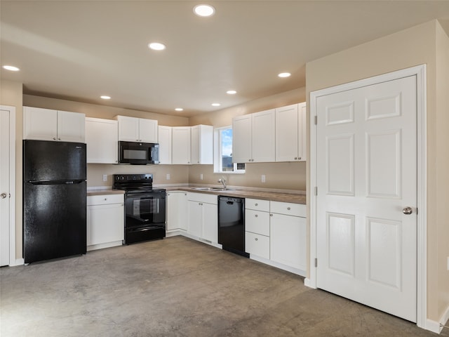 kitchen featuring black appliances, concrete floors, white cabinetry, a sink, and recessed lighting