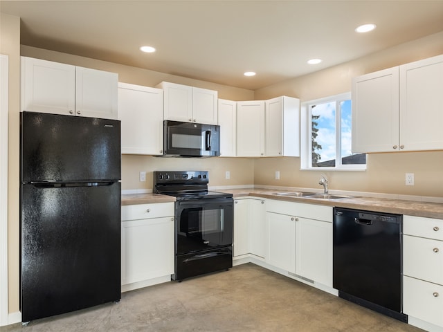 kitchen with black appliances, white cabinetry, a sink, and recessed lighting