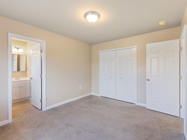 113 Washington St, Sheridan, MT 59749 - unfurnished bedroom featuring a closet, baseboards, a sink, and ensuite bath