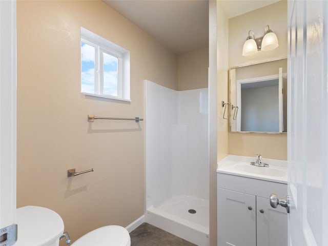 bathroom featuring toilet, a shower stall, baseboards, and vanity