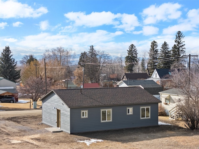 view of home's exterior with a shingled roof