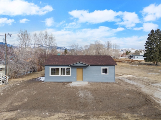 view of front of property featuring roof with shingles