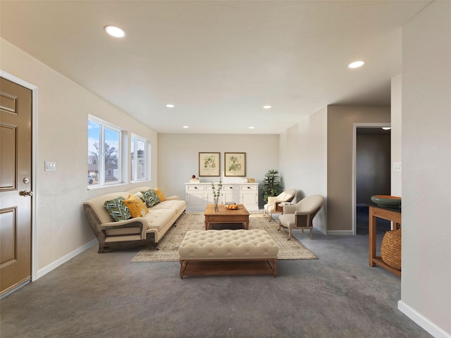 carpeted living area featuring baseboards and recessed lighting