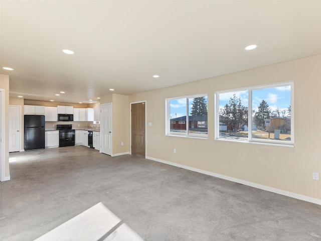 113 Washington St, Sheridan, MT 59749 - unfurnished living room with baseboards, recessed lighting, and concrete floors