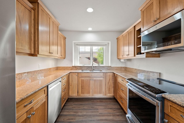 kitchen featuring light stone counters, dark wood finished floors, open shelves, stainless steel appliances, and a sink