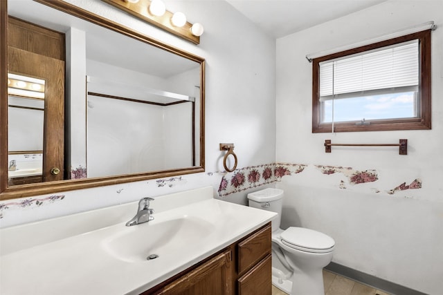 full bathroom with a shower with shower door, vanity, and toilet