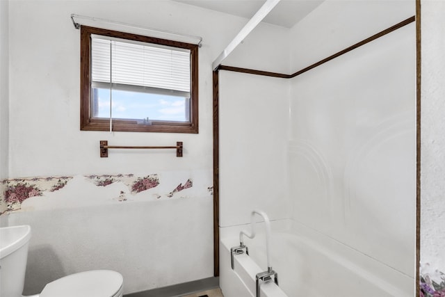 bathroom featuring bathing tub / shower combination and toilet