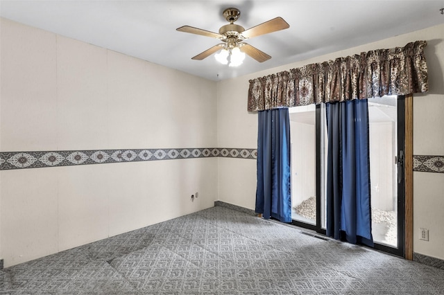 unfurnished room with visible vents, carpet flooring, and a ceiling fan