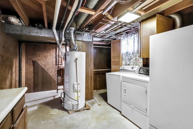 unfinished basement featuring gas water heater and washing machine and clothes dryer