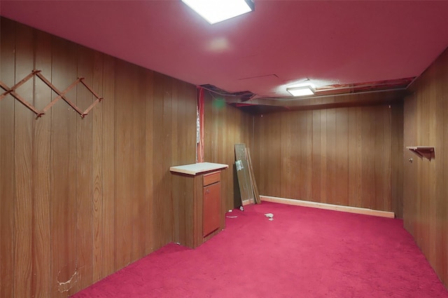 interior space featuring carpet and wooden walls