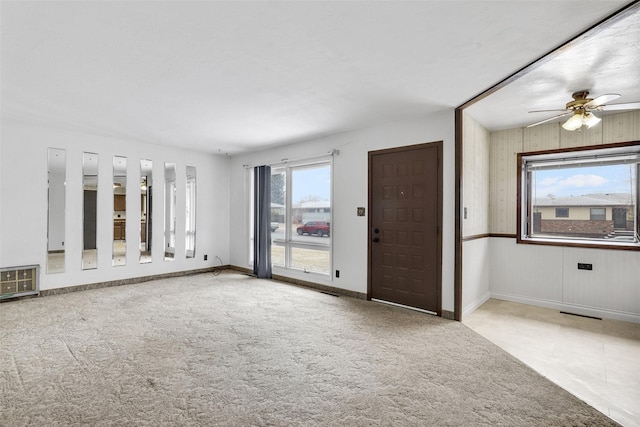 interior space featuring ceiling fan, carpet flooring, and baseboards