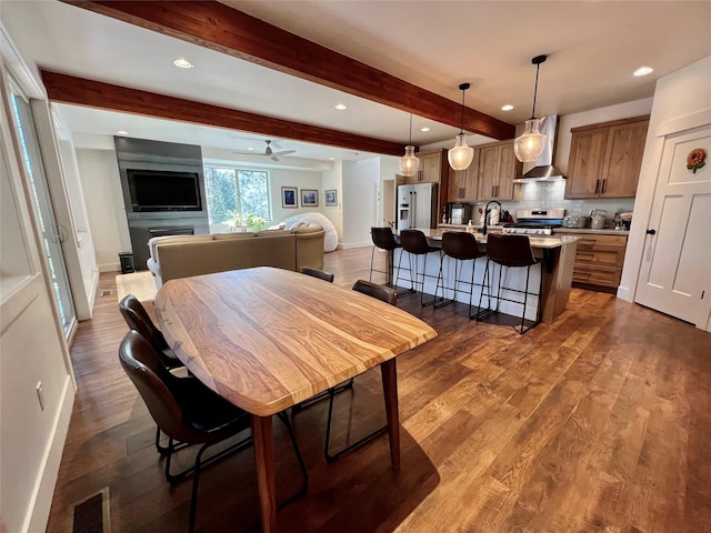 dining space with recessed lighting, dark wood-type flooring, visible vents, baseboards, and beamed ceiling