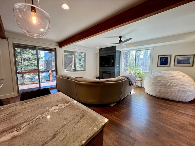 living room with dark wood-style flooring, a fireplace, recessed lighting, a ceiling fan, and beamed ceiling