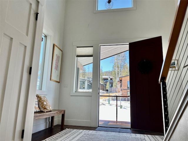 doorway featuring wood finished floors and baseboards