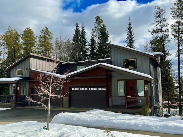 view of front of property with covered porch, board and batten siding, and an attached garage