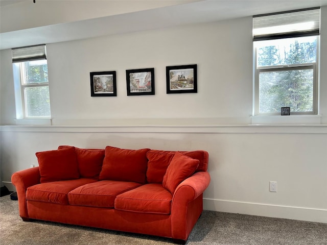 living area with baseboards and carpet flooring