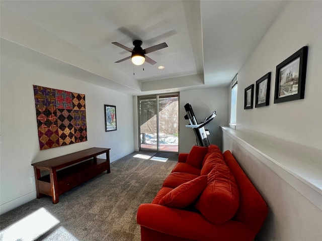 carpeted living area featuring baseboards, a raised ceiling, a ceiling fan, and recessed lighting