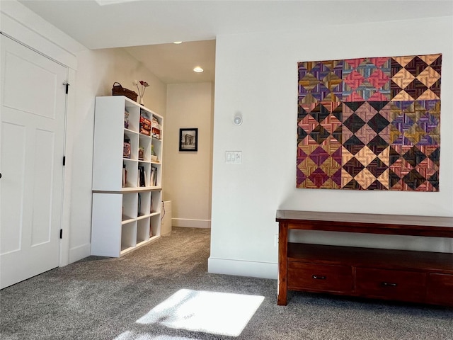 unfurnished room featuring carpet floors and baseboards