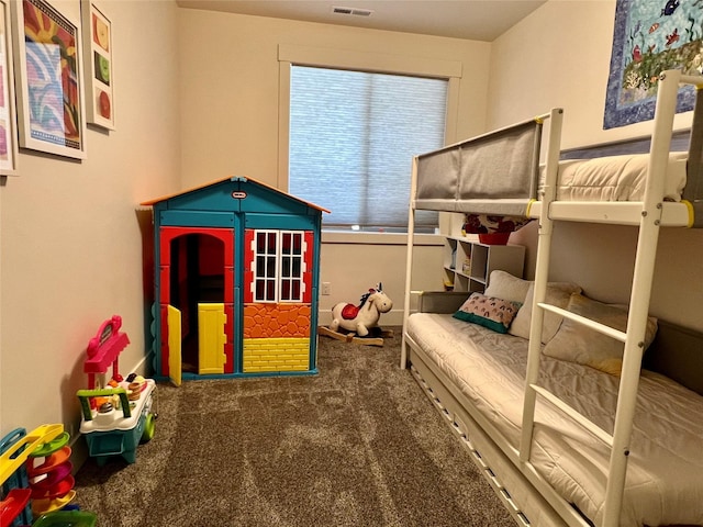 carpeted bedroom featuring visible vents