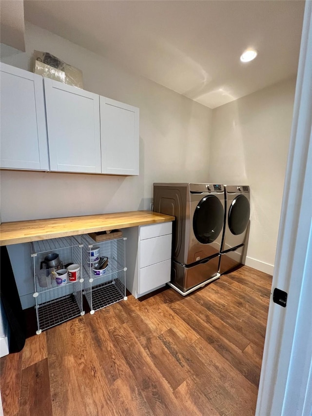 laundry area featuring washing machine and clothes dryer, recessed lighting, cabinet space, dark wood-type flooring, and baseboards